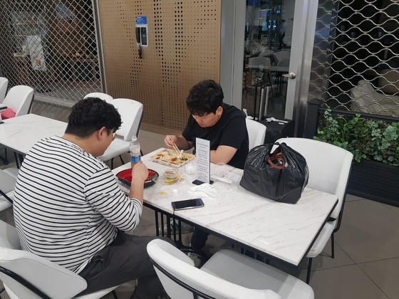 늦은 밤 인천공항 2터미널 지하1층 식당가에서 두 청년이 편의점 도시락을 먹고 있다. 함종선 기자 