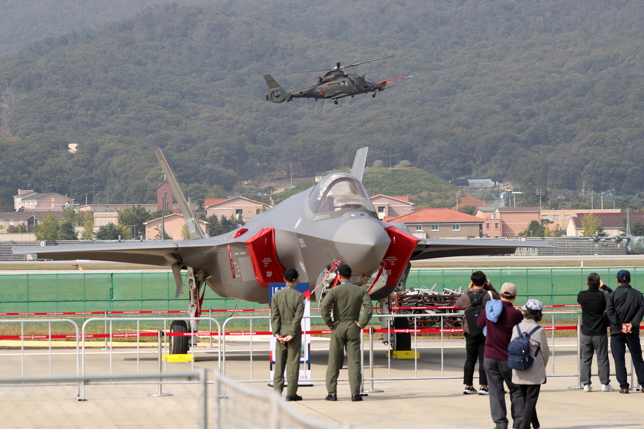 서울 ADEX 2019 프레스 데이에서 F-35A 뒤로 소형무장헬기(LAH)의 비행이 진행되고 있다. [뉴스1]
