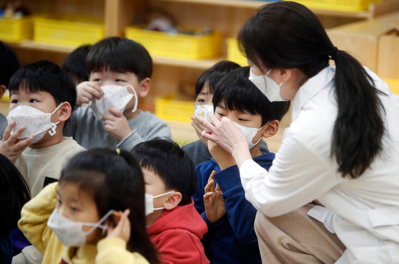 지난달 30일 광주 북구청 직장어린이집에서 보건소 직원이 원아에게 감염병 예방을 위한 마스크 착용법을 안내하고 있다. [연합뉴스]