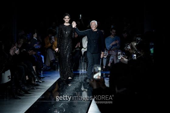 MILAN, ITALY - FEBRUARY 23: ( EDITOR NOTE: This image has been altered with digital filters) Designer Giorgio Armani acknowledges the applause of the public after the Giorgio Armani show at Milan Fashion Week Autumn/Winter 2019/20 on February 23, 2019 in Milan, Italy. (Photo by Vittorio Zunino Celotto/Getty Images)