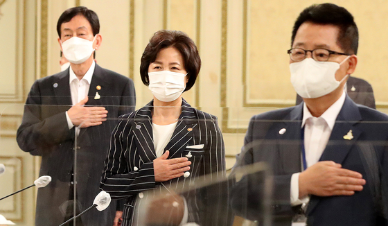 Public Administration and Security Minister Jin-young (left to right), Justice Minister Chu Mi-ae, and National Intelligence Service chief Park Ji-won salute the national flag at the 2nd meeting of a strategy of police, fiscal and national intelligence reform held at the Blue House on the afternoon of the 21st. [연합뉴스]