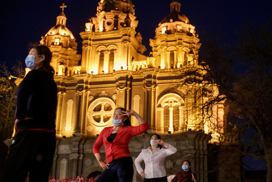 In April, Chinese citizens are doing gymnastics in front of St. Joseph's Cathedral in Beijing, China.[로이터=연합뉴스]