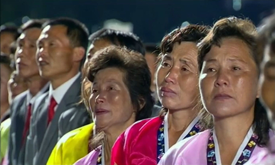 On the afternoon of the 10th, North Korea's Chosun Joongang TV broadcasts a feverish ceremony celebrating the 75th anniversary of the founding of the Labor Party.  North Koreans mobilized for a large-scale fever ceremony cry as they listen to a speech by North Korean leader Kim Jong-un. [조선중앙TV=뉴시스]