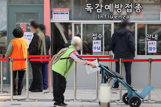 27일 서울 시내 한 병원을 찾은 내원객들이 인플루엔자(독감) 백신 예방 접종을 위해 차례를 기다리고 있다. [연합뉴스]