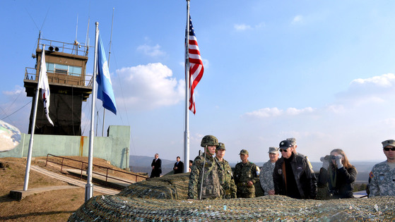 In December 2013, President-elect Joe Biden, then Vice President of the United States (second from right in the front row), visited the Olet Post (GP) near Panmunjom, South Korea, and the platoon commander of the Guard of the Joint Security Area (JSA) informs it.  [사진공동취재단]