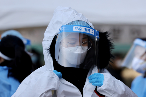 On the afternoon of the 25th, when there were 1,200 new confirmed cases of corona19, medical personnel are wearing protective clothing at a temporary screening clinic set up in Seoul Plaza.  Yunhap news