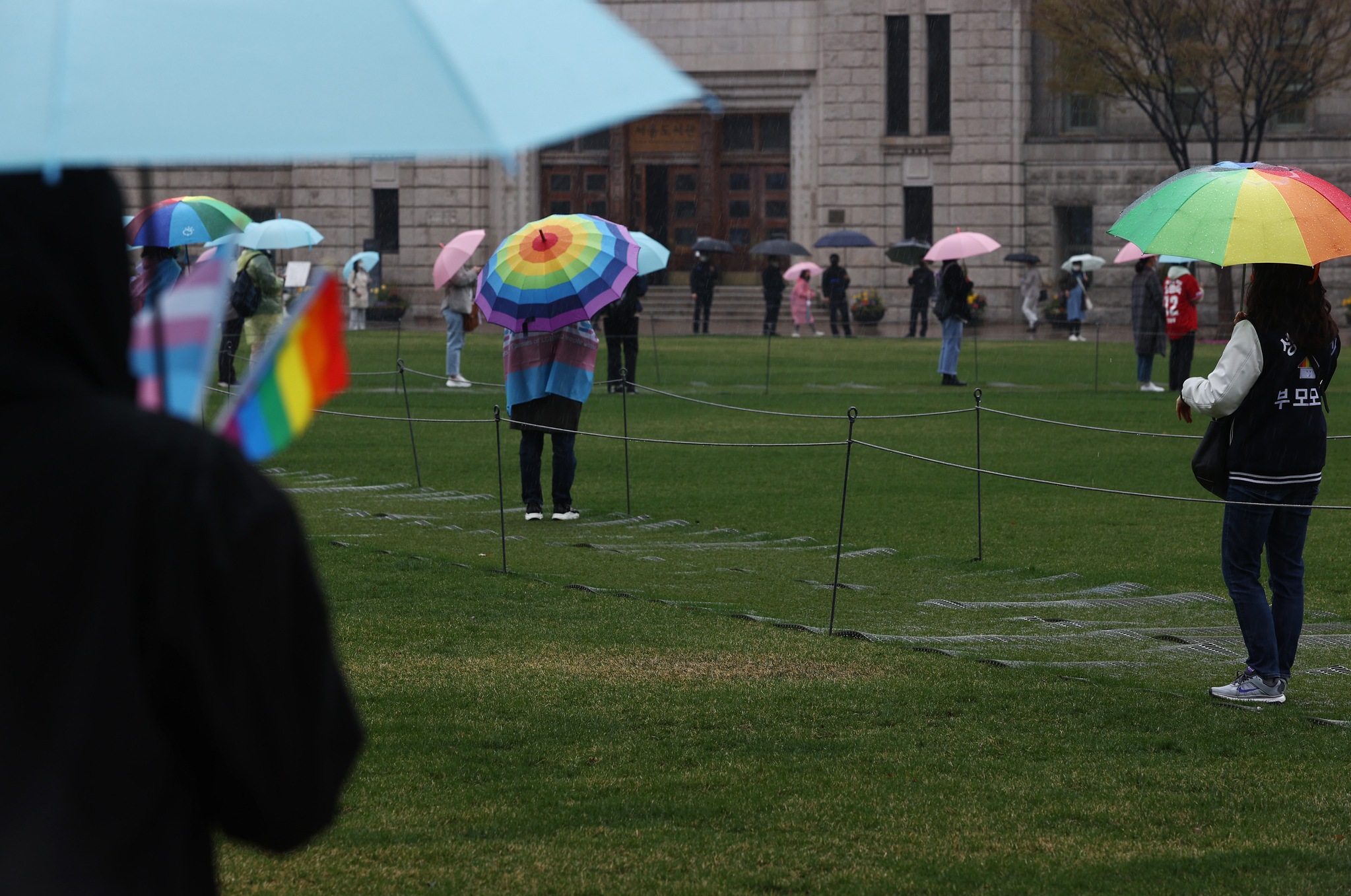 Participants stand at a distance at a joint press conference on 'Transgender Awareness Day' hosted by the 'Joint Countermeasures Committee for Reincorporation and Honor Recovery of Sergeant Byeon Hee-Soo in Seoul Plaza in the afternoon from the 27th. Yunhap news 